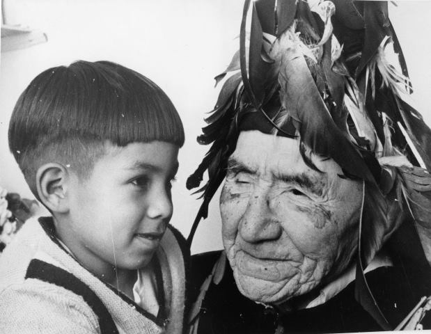 Chief August Jack holding young child