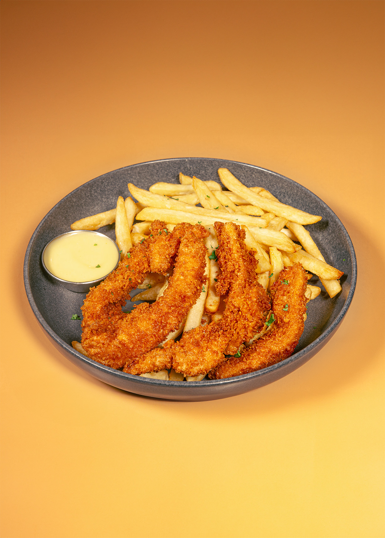 closeup of chicken strips and fries