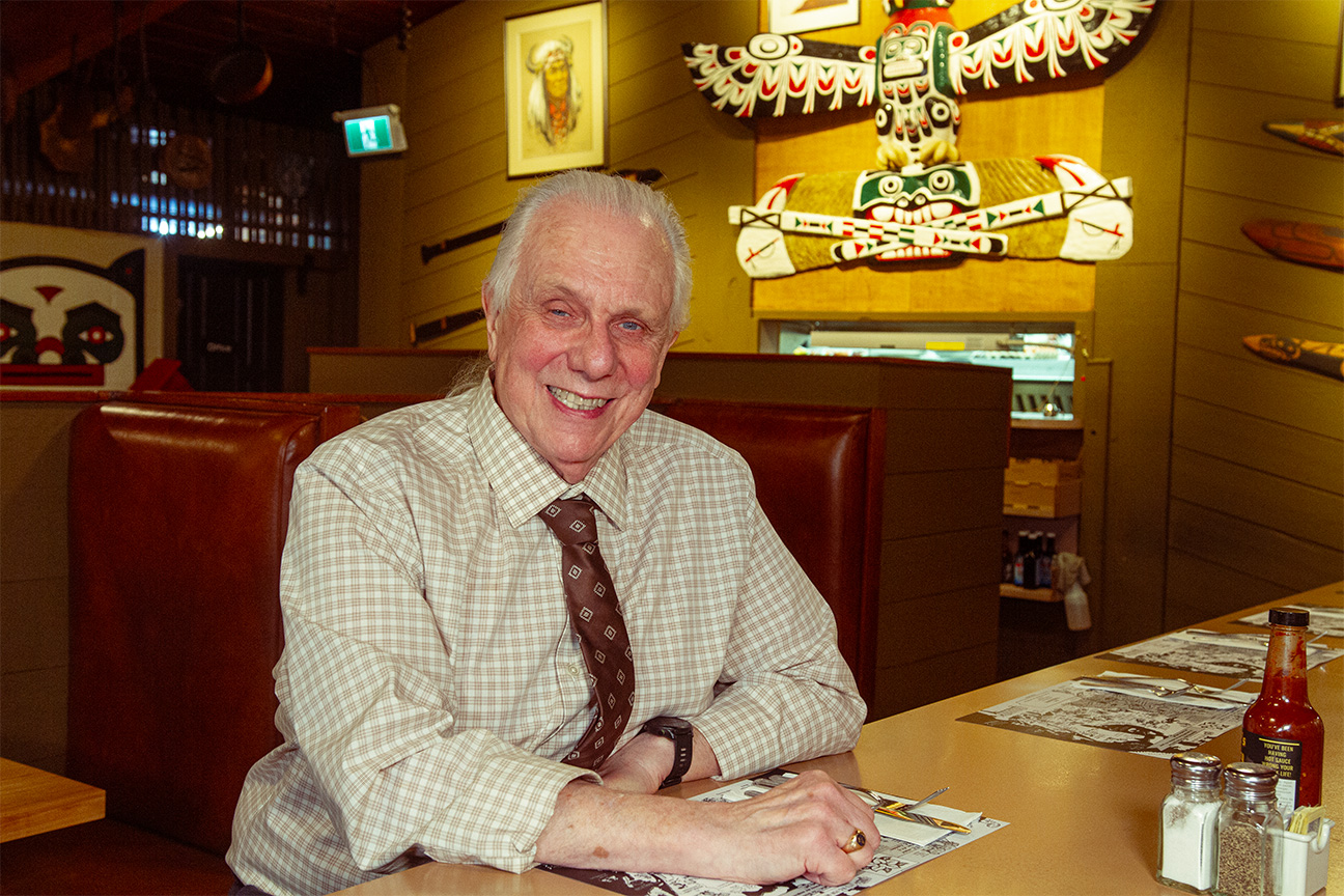 smiling owner in collared shirt and tie