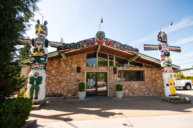 front of restaurant with two Totem Poles on either side