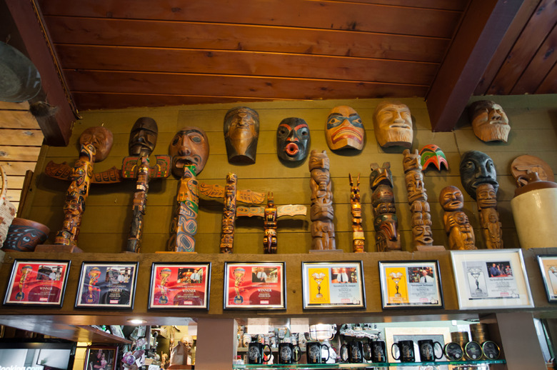 First Nations carvings and artwork displayed on wall